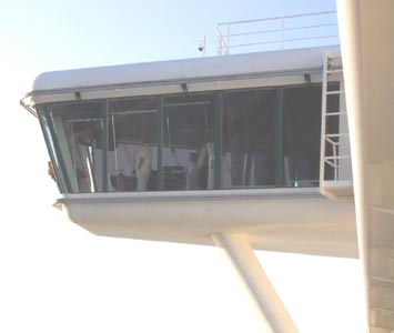 The local pilot and captain navigate away from the dock